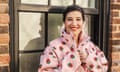 Renée DiResta poses outdoors in a pink fleece with strawberries on it