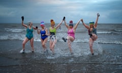 Swimmers take part in a sunrise dip in the North Sea at Portobello beach near Edinburgh to mark International Women’s Day