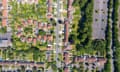 Aerial footage of the suburban houses and village of Welwyn Garden City in Hertfordshire on a hot, sunny summer day