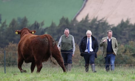 Boris Johnson (centre) with farmer Peter Watson (left) and Scottish secretary Alister Jack on a visit to Darnford Farm in Banchory near Aberdeen