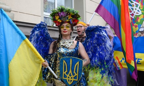 A drag queen holds a shield bearing Ukraine’s coat of arms at the pride march earlier today.