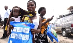 A woman holds a treated mosquito net during a malaria prevention event in the Eti-Osa East district of Lagos on 21 April 2016.