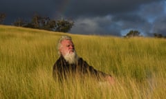 Bruce Pascoe sits among Australian native plant Mandadyan Nalluk (dancing grass) at his property in East Gippsland, Victoria