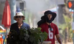 two people wearing hats walk