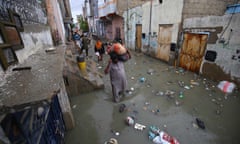 Monsoon rains flood streets of Karachi<br>epa08624493 People make their way through a flooded road after heavy rains in Karachi, Pakistan, 25 August 2020. Heavy monsoon rain flooded several areas of Karachi causing traffic jams and power outages. EPA/SHAHZAIB AKBER