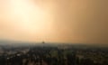 TOPSHOT-CANADA-WILDFIRE<br>TOPSHOT - Smoke from the McDougall Creek wildfire envelops Kelowna, British Columbia, Canada, on August 18, 2023. Wildfires bore down on Canada's Yellowknife and Kewlona August 18, 2023, with firefighters in the west bracing for another "scary" night as stunned refugees from the far north began arriving at shelters after their entire city was evacuated. The blazes have caused "terrible loss," Prime Minister Justin Trudeau told reporters after meeting evacuees from Yellowknife, capital of the Northwest Territories, as they arrived in Edmonton, Alberta. (Photo by Darren HULL / AFP) (Photo by DARREN HULL/AFP via Getty Images)