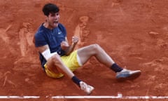 Carlos Alcaraz celebrates beating Alexander Zverev in five sets in the French Open final, with a white sleeve protection for his forearm.