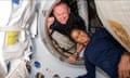 man and woman pose in spacecraft