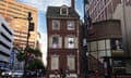 brick building with three rows of windows in the city