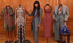 Naomi Campbell at the press launch for the V&A's upcoming Naomi: In Fashion exhibition accompanied by mannikins wearing designer dresses