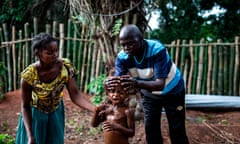 A health worker and a mother try to get the fever down of a boy, at a makeshift paediatric health centre after an outbreak of malaria hit the village on June 11, 2017 in Muma. The Malaria outbreak was seeing 40 cases a day and about 2-3 deaths per day in the district of Muma. 