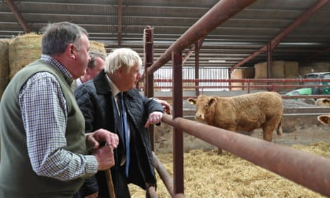 Boris Johnson (right) being shown around Darnford Farm in Banchory near Aberdeen