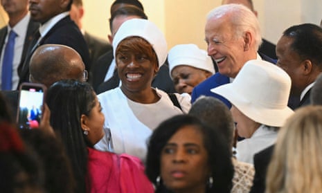 white man surrounded by people smiles