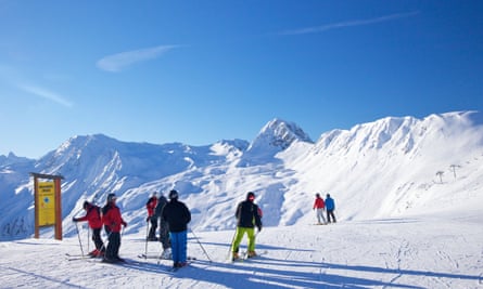 A group of skiers high up in the French Alps