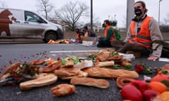 Activists in Berlin, Germany, block a highway to protest against food waste and for agricultural change to reduce greenhouse gas emissions.