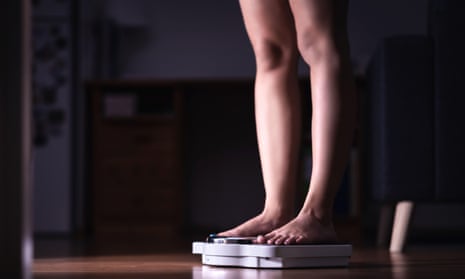 Feet standing on weighing scales