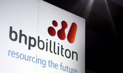 A promotional sign adorns a stage at a BHP Billiton function in central Sydney in this August 20, 2013 file photo. Australia is pursuing global miners BHP Billiton and Rio Tinto for shifting billions of dollars in iron ore profits through marketing hubs in Singapore that pay almost no tax, the Australian Financial Review reported on April 7 , 2015. REUTERS/David Gray/Files