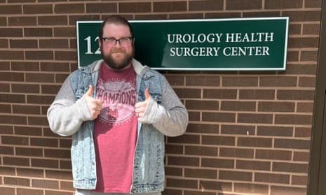 man with thumbs up next to sign reading 'urology health surgery center'