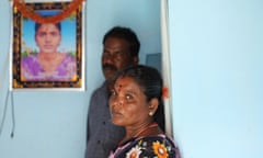 Muthulakshmi and Kathiravel, parents of Jayasre Kathiravel, stand besides the portrait of her daughter Jayasre at there residence on the outskirts of Dindigul city in Tamil nadu state, April 21, 2022. Photo: Sivaram V for The Guardian