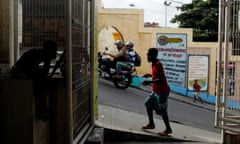 People walk past closed shops at the Complexo do Alemao slum in Rio de Janeiro May 23, 2013. Drug traffickers in Rio de Janeiro ordered shops shut in Complexo do Alemao slum, one of its biggest, early Thursday, forcing school closures, defying efforts to restore order to the city's vast shantytowns and renewing safety concerns in Brazil before it hosts the World Cup, Olympics and other big upcoming events.