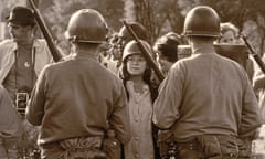 Protestor Eyes Riot Police Outside 1968 Democratic National Convention<br>A young female protester wearing a helmet faces down helmeted and armed police officers at an anti-Vietnam War demonstration outside the 1968 Democratic National Convention, Chicago, Illinois, August 1968. (Photo by Hulton Archive/Getty Images)