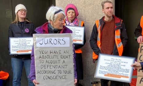 Trudi Warner, second left, and supporters hold up signs outside the Old Bailey in central London, April 2023.