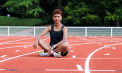 Farida Abaroge sitting on an athletics track.