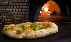 Pizza fresh out of the oven at a Naples pizzeria.