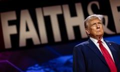 Trump on stage in front of a large sign saying 'Faith'