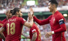 Cristiano Ronaldo celebrates with teammate Ruben Neves after putting Portugal 2-0 up.
