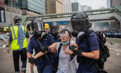 A protester is arrested on the street in Hong Kong.
