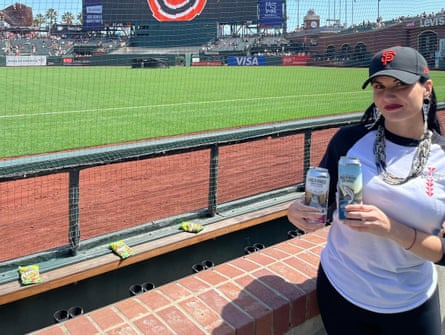 Cooley holds drink cans while wearing Giants cap