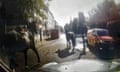 Grainy dashcam footage of two horses trotting past an RAC van waiting at traffic lights in central London