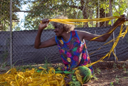 Evonne dries off the freshly dyed pandanus