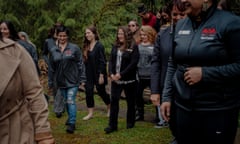 A large group of women walk outdoors