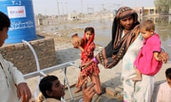 People displaced by the 2010 flooding in Pakistan collect clean drinking water from a tapstand in the town of Ghari Kharo, in western Sindh Province. UKaid funding from the British government's Department for Intrernational Development is helping the NGO Mercy Corps deliver clean water and sanitation facilities to over 160,000 people in Sindh, as they return home to destroyed houses and partially flooded communities and agricultural land. In some parts of Sindh the water may take many months more to fully drain away, despite the flooding originally occuring in August and September 2010. More than 20 million people were affected across Pakistan, making the flooding possibly the single biggest humanitarian crisis the world has ever seen.