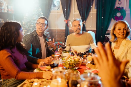 People sitting at a dining table for Christmas meal