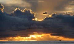 A US military helicopter flies over the waters of Agana Bay in Hagatna, Guam.