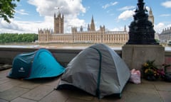 People rough sleeping in tents next to the River Thames opposite the Palace of Westminster