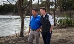 NSW Premier Chris Minns and Barwon independent MP Roy Butler walk along the Darling-Baaka in Menindee at the site where fish carcasses began being excavated from the river on Thursday, after the recent fish kill event.