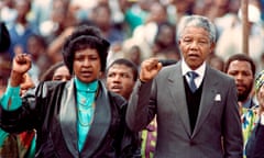 Nelson Mandela and Winnie Madikizela-Mandela (L) raise their clenched fists at Soweto Soccer City stadium, during a rally.