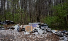 graffiti on a rock in a forest reads 'acab' and 'the forest is my home'