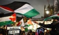 Pro-Palestinian demonstrators wave Palestinian flags and hold placards in Parliament Square, London