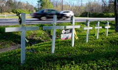 white crosses along a roadside memorialize victims of a shooting