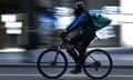 A delivery cyclist on the road.