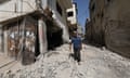 A man walks past destroyed apartment buildings after an Israeli raid in Jenin, occupied West Bank on 14 June.