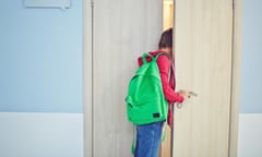 Schoolboy looking into classroom