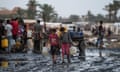 Palestinians gather to fill water vessels near one of the strip's few functioning desalination plants in Deir al-Balah.