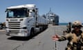 A truck carries humanitarian aid across Trident Pier, a temporary pier to deliver aid, off the Gaza Strip, amid the ongoing conflict between Israel and Hamas, near the Gaza coast, 25 June 2024.