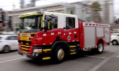 A fire truck moves through a Melbourne intersection.